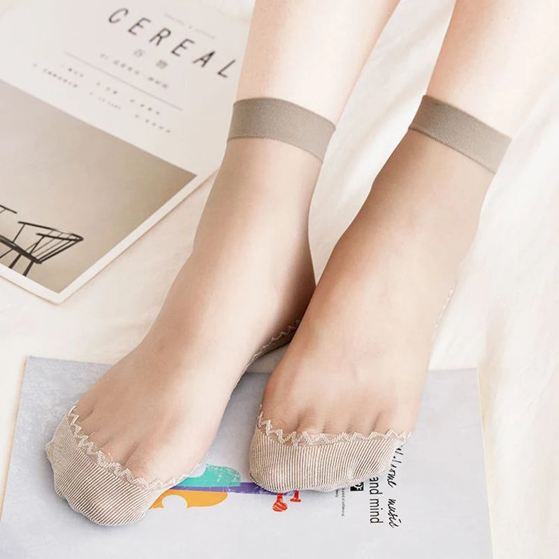 A pair of beige ultra-thin breathable ankle socks worn on a person's feet against a light background.