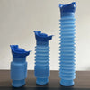 Three stacked blue portable telescopic urinals standing upright on a wooden surface.