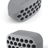 A gray silicone jawline exerciser with multiple circular holes, shown from a top-down angle.