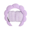 A lavender microfiber skincare headband and wristband set.