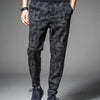 Men's camouflage elastic waist drawstring pants shown on a model.
