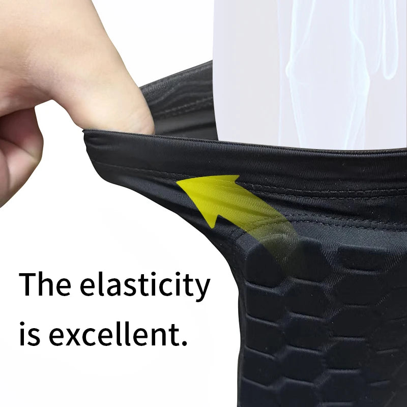 Close-up of a black honeycomb shin guard showing excellent elasticity on a foot.