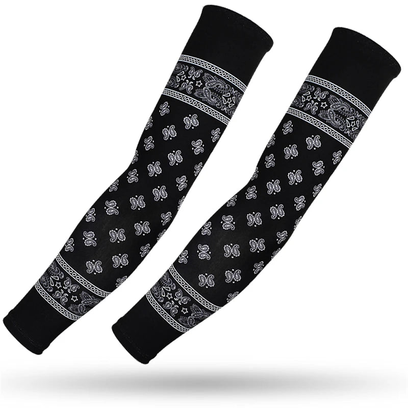 A pair of black sports arm sleeves featuring white paisley and geometric patterns.