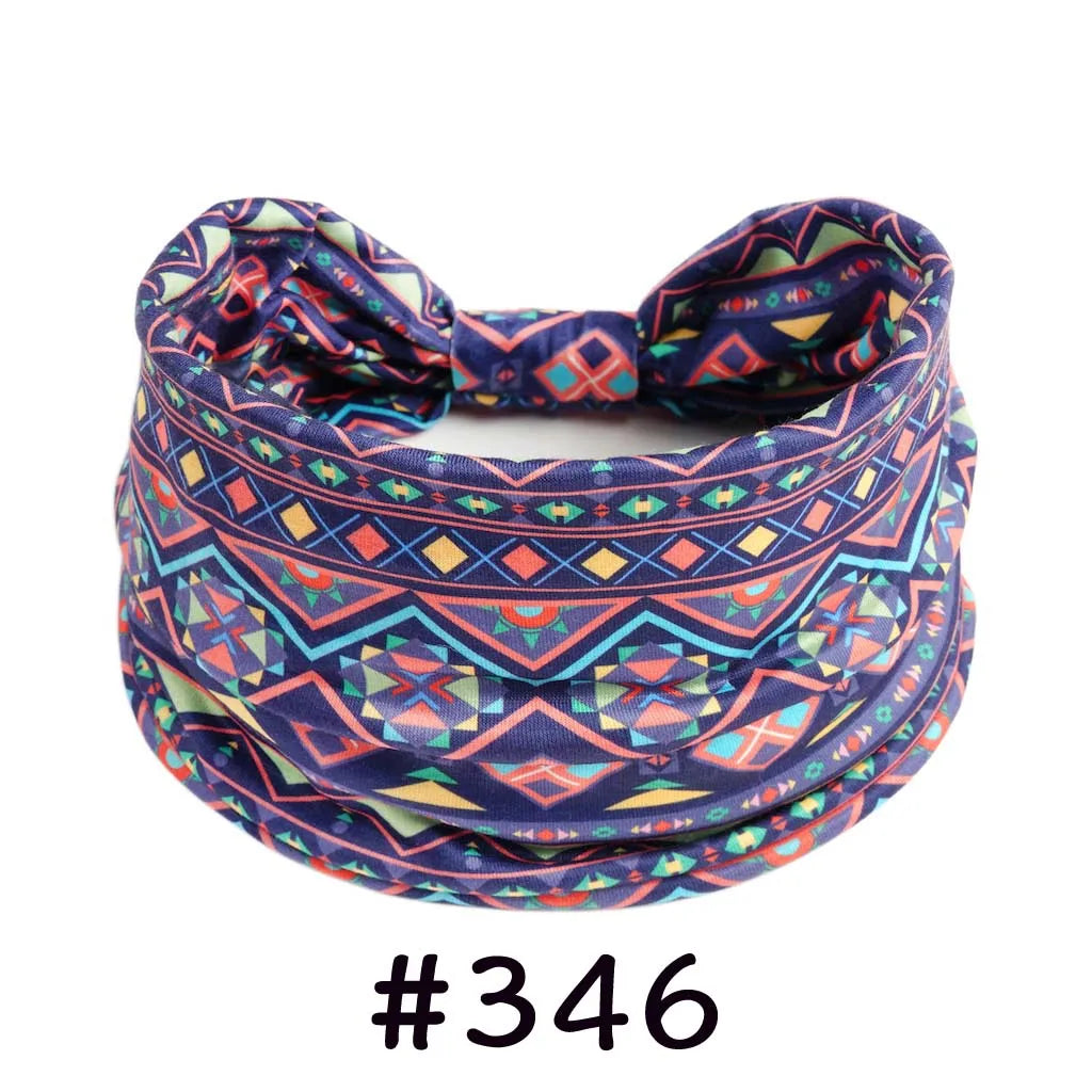 Boho knotted cotton headband featuring a vibrant geometric pattern in purple, blue, and orange tones.