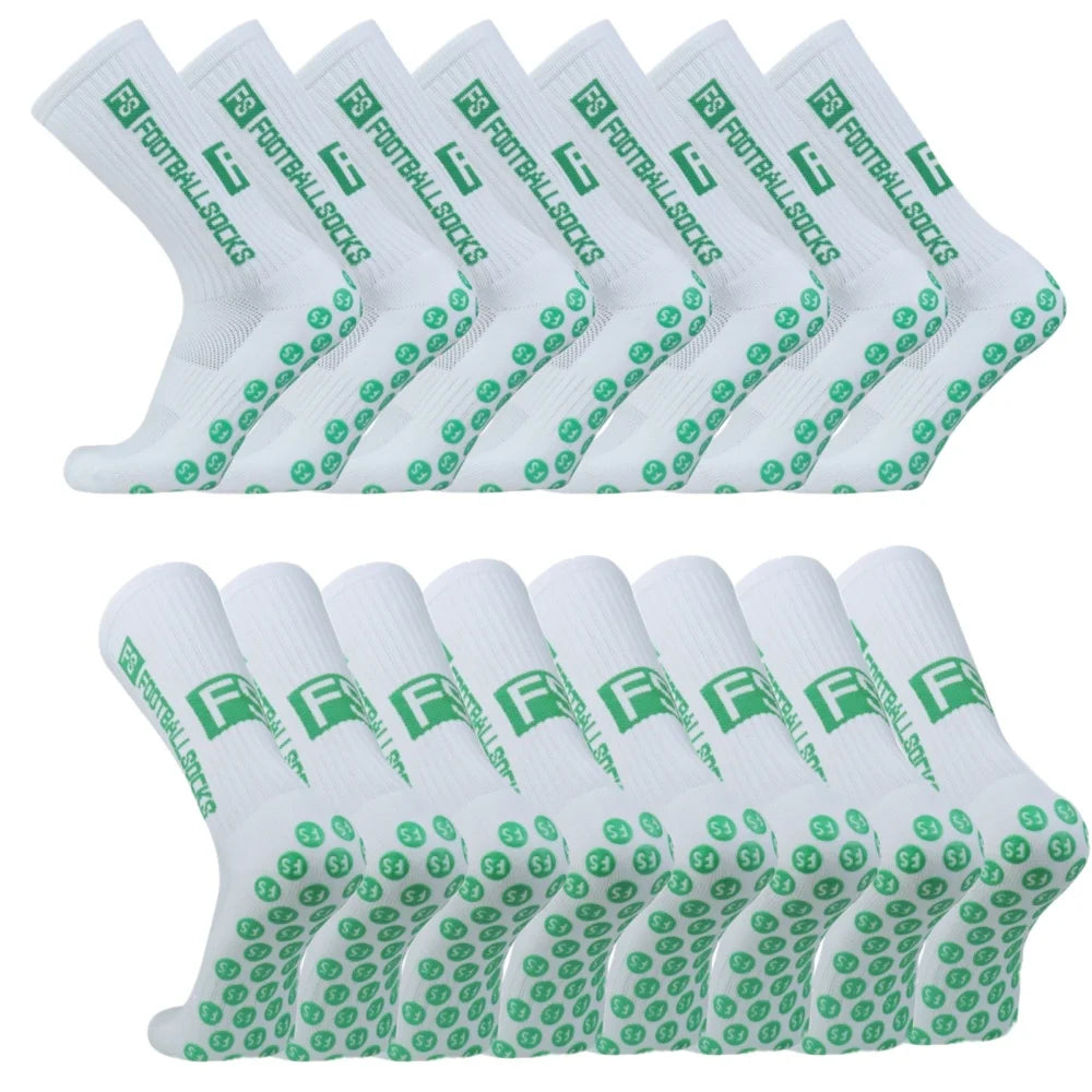 A set of white non-slip grip socks with green text and logos arranged in a row.