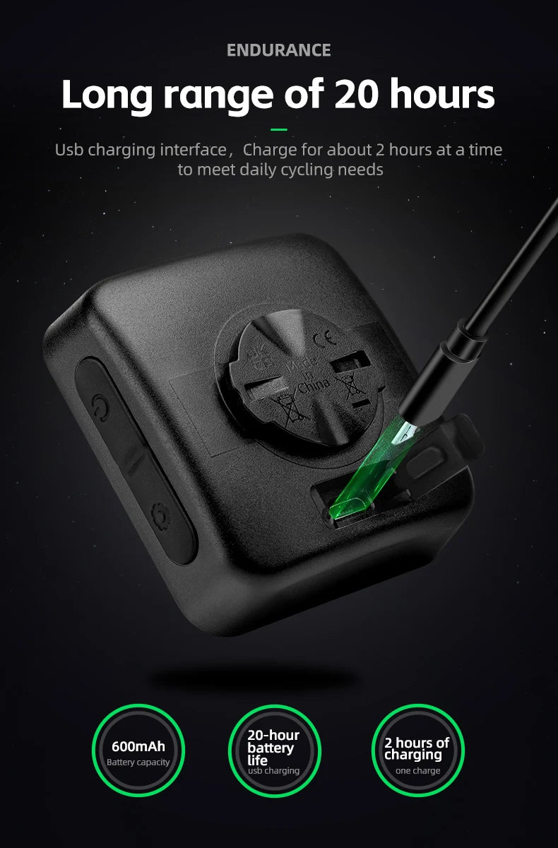 Black GPS cycling computer and speedometer with a charging cable shown against a dark background.