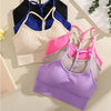 A collection of ribbed crop tops in various colors including purple, black, blue, pink, and cream laid out on a light surface