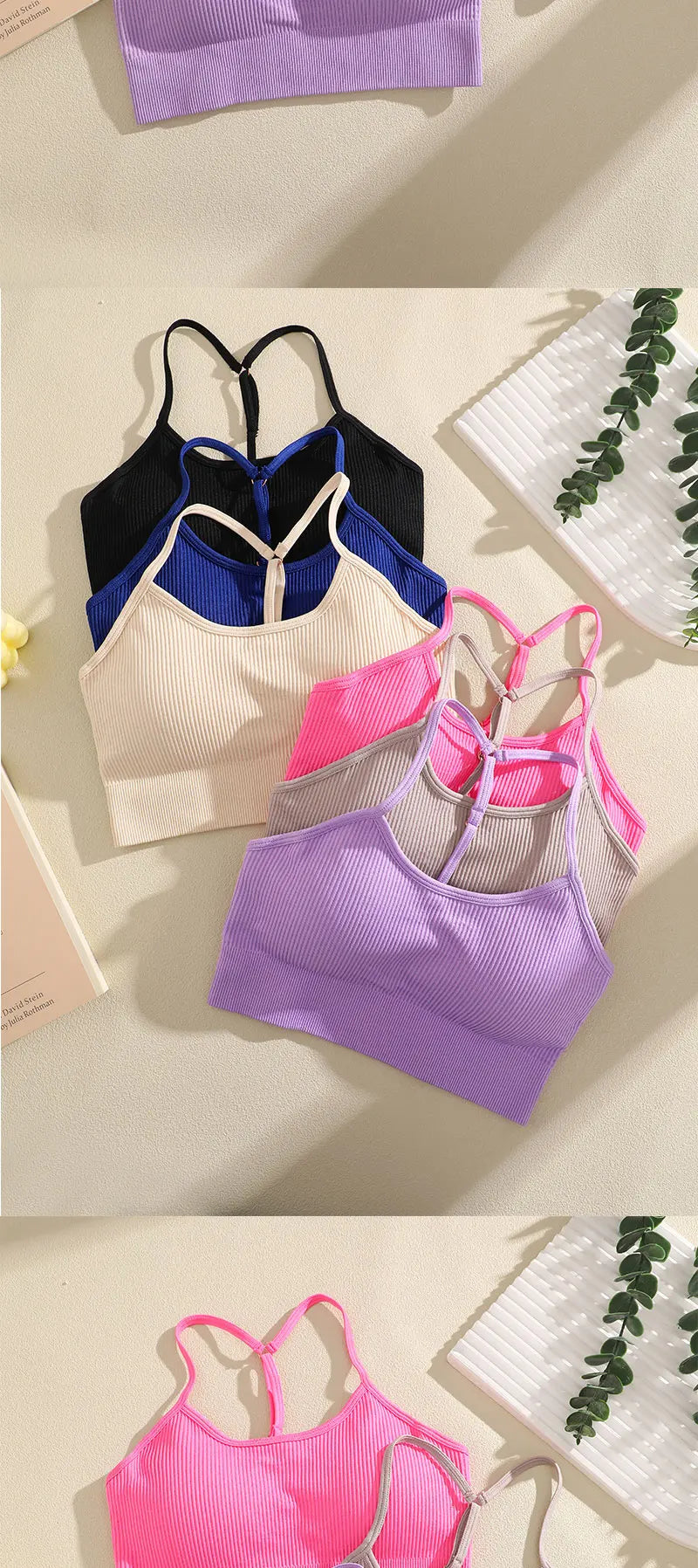 A collection of ribbed crop tops in various colors including purple, black, blue, pink, and cream laid out on a light surface