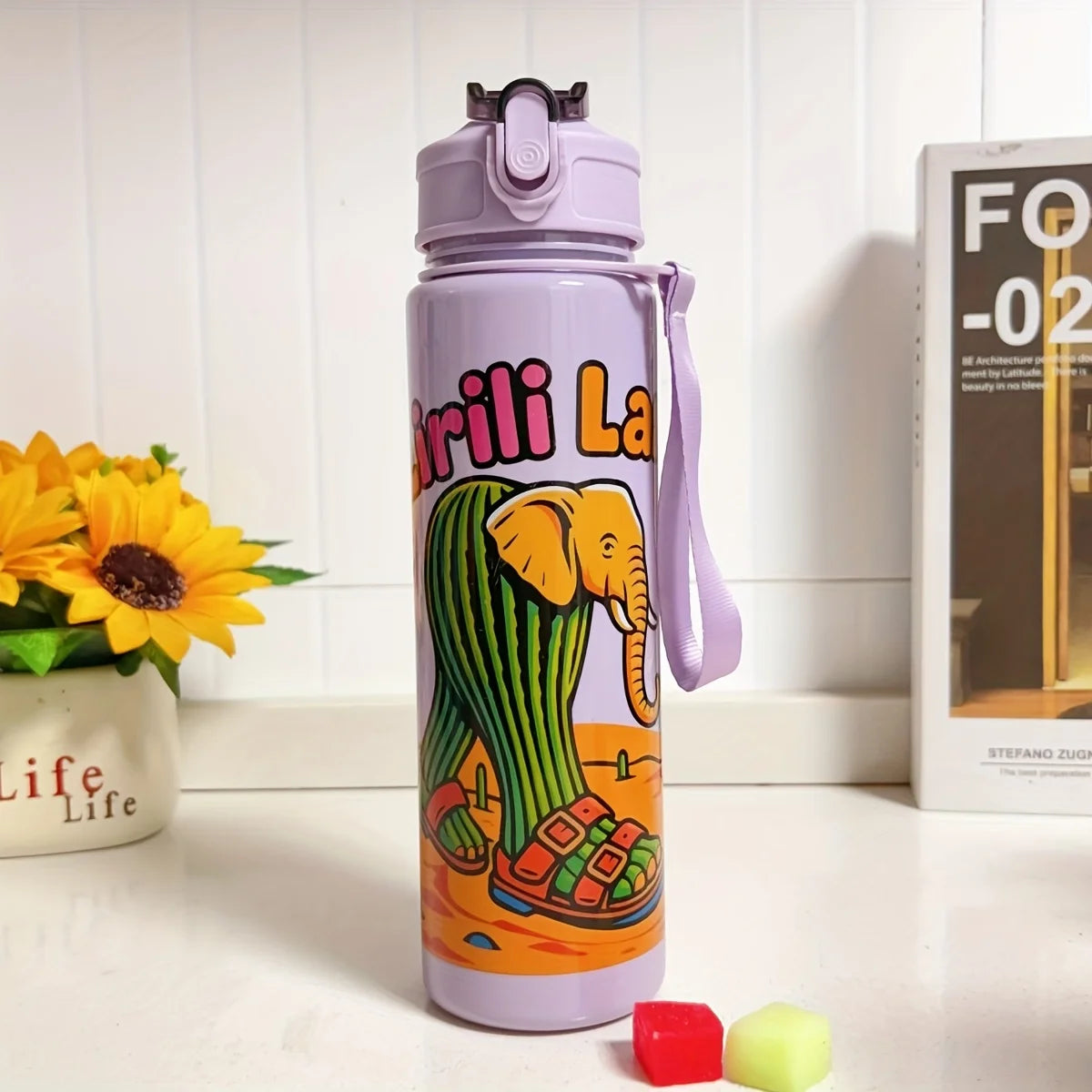 A purple insulated sports water bottle with an elephant design is shown on a white surface.