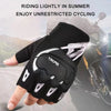A hand is holding a black and white cycling glove with a clear design against a blurred background of a motorcycle.