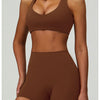A model wearing a brown padded sport yoga bra and matching bottoms.