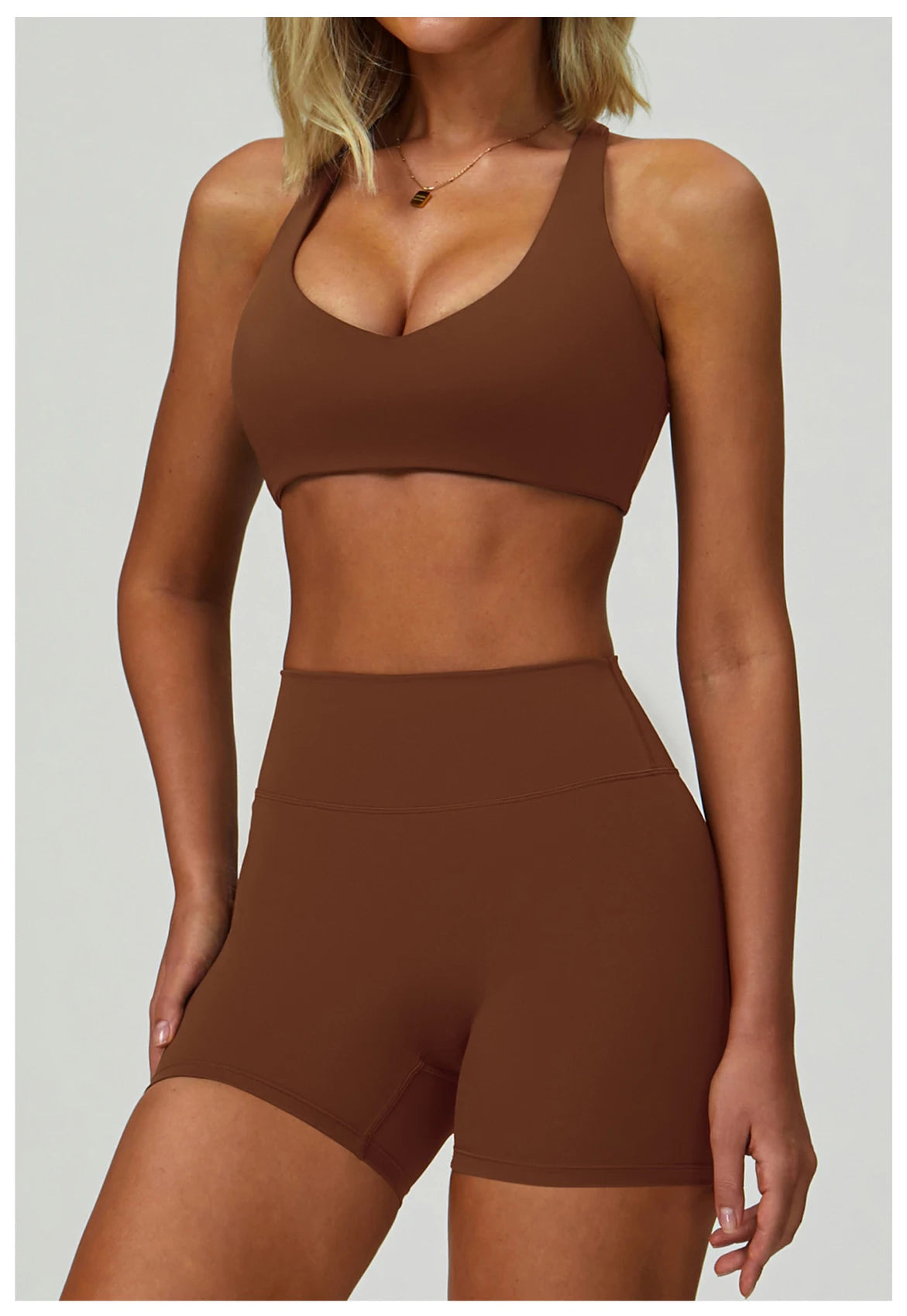 A model wearing a brown padded sport yoga bra and matching bottoms.