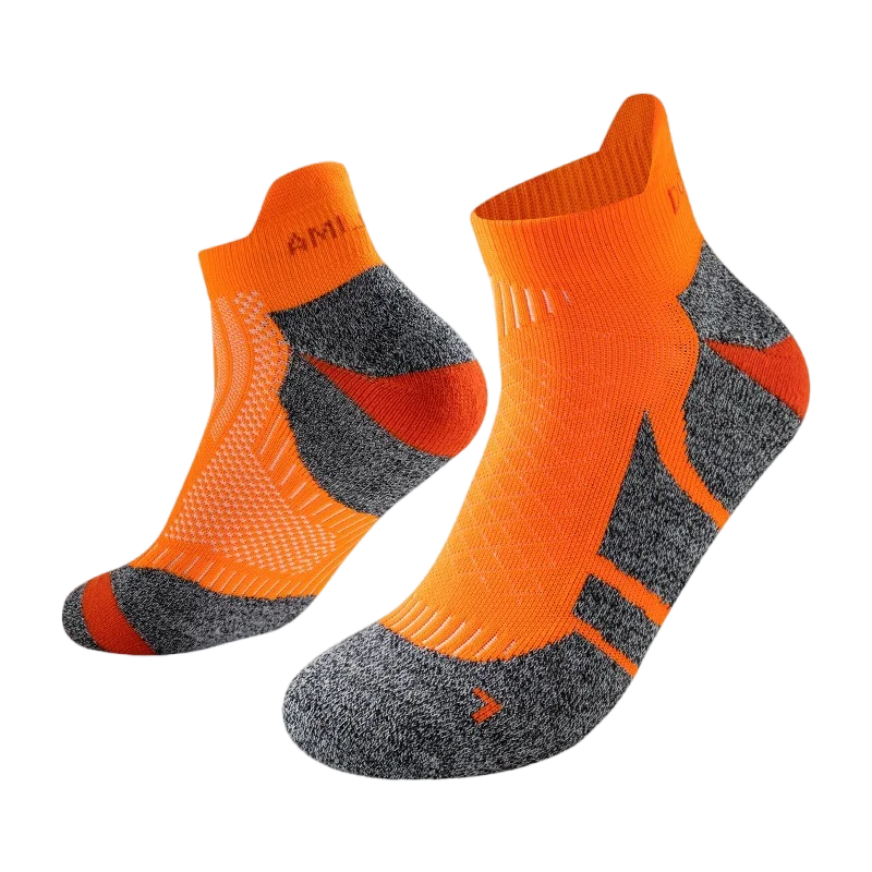 A pair of bright orange performance sports ankle socks with gray accents, shown from the side.
