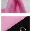 Close-up view of a pink multipurpose drawstring storage bag with a black cord and a silver ring.