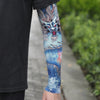Close-up of a person wearing blue and white dragon tattoo sleeves on their arm.