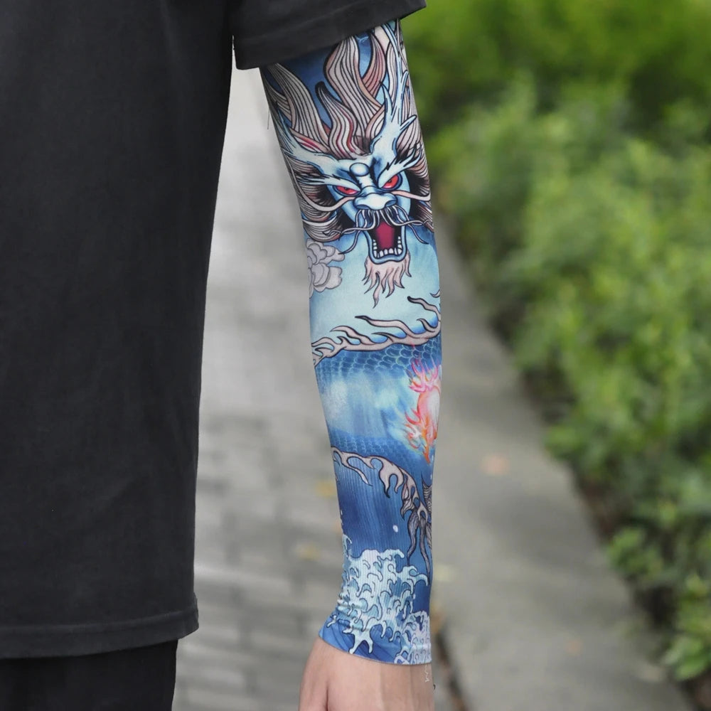 Close-up of a person wearing blue and white dragon tattoo sleeves on their arm.