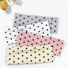 A set of four polka dot elastic hair bands in shades of pink, black, white, and gray are displayed on a white background.