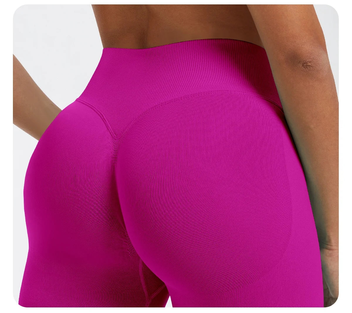 A close-up shot of a woman wearing bright magenta seamless high-waist yoga leggings.