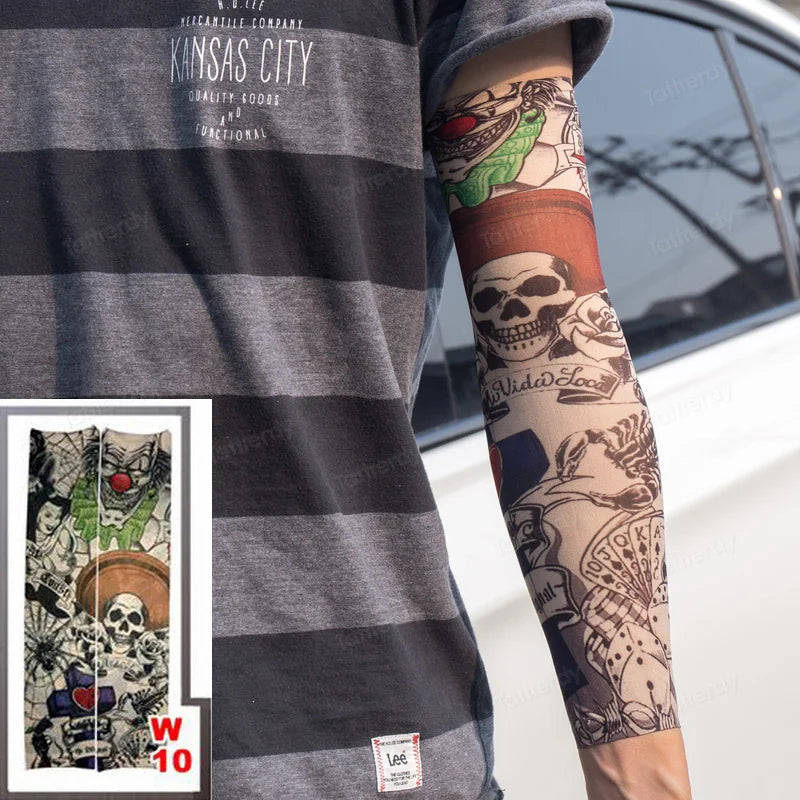 A person wearing a gray t-shirt displays colorful tattoo designs on their forearm, featuring skulls and floral elements.