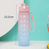 A pink sports water bottle with a straw and motivational time markers is shown against a light teal background.