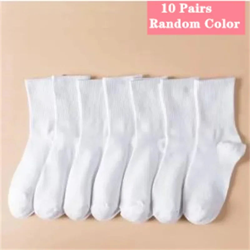 Ten pairs of random colored white socks laid out in a row.