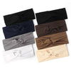 A collection of knotted elastic sports headbands in black, navy blue, gray, brown, and cream.