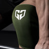 A close-up of olive green compression knee sleeves with a white geometric logo on a person's leg.