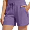 Purple high-waisted quick-dry athletic shorts being held by a woman.