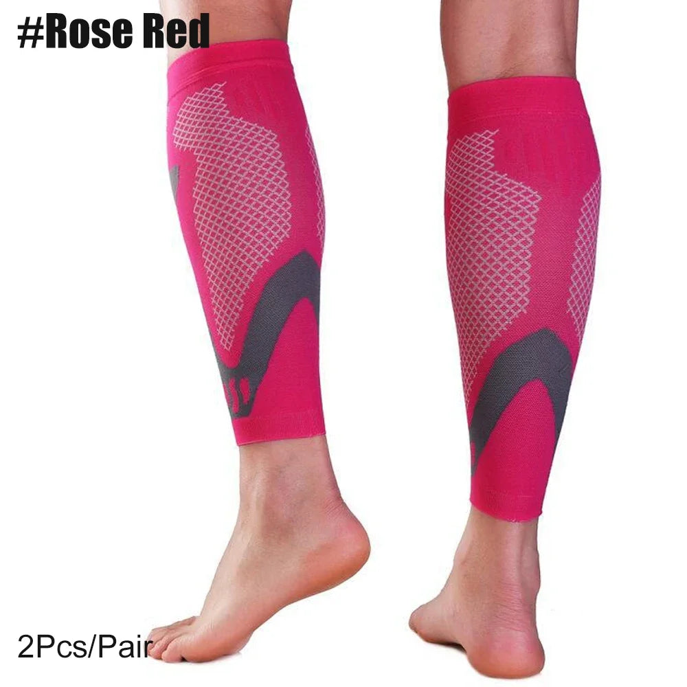 Pair of bright pink compression sleeves for the calf, shown on a foot.