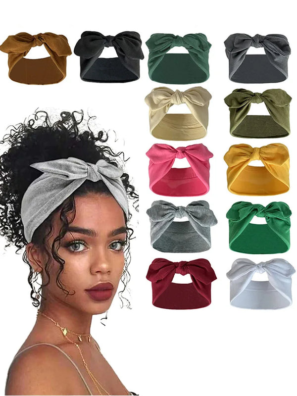 A collection of solid color elastic headbands in various shades including brown, black, green, beige, yellow, pink, and gray.