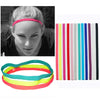 A collection of five brightly colored elastic silicone sports headbands in various stripes.