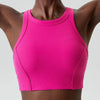 A magenta ribbed high-impact stretch yoga crop top worn by a model.