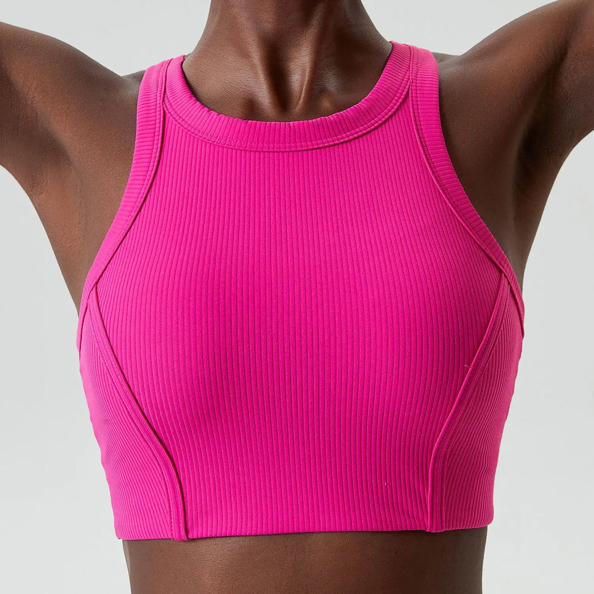 A magenta ribbed high-impact stretch yoga crop top worn by a model.