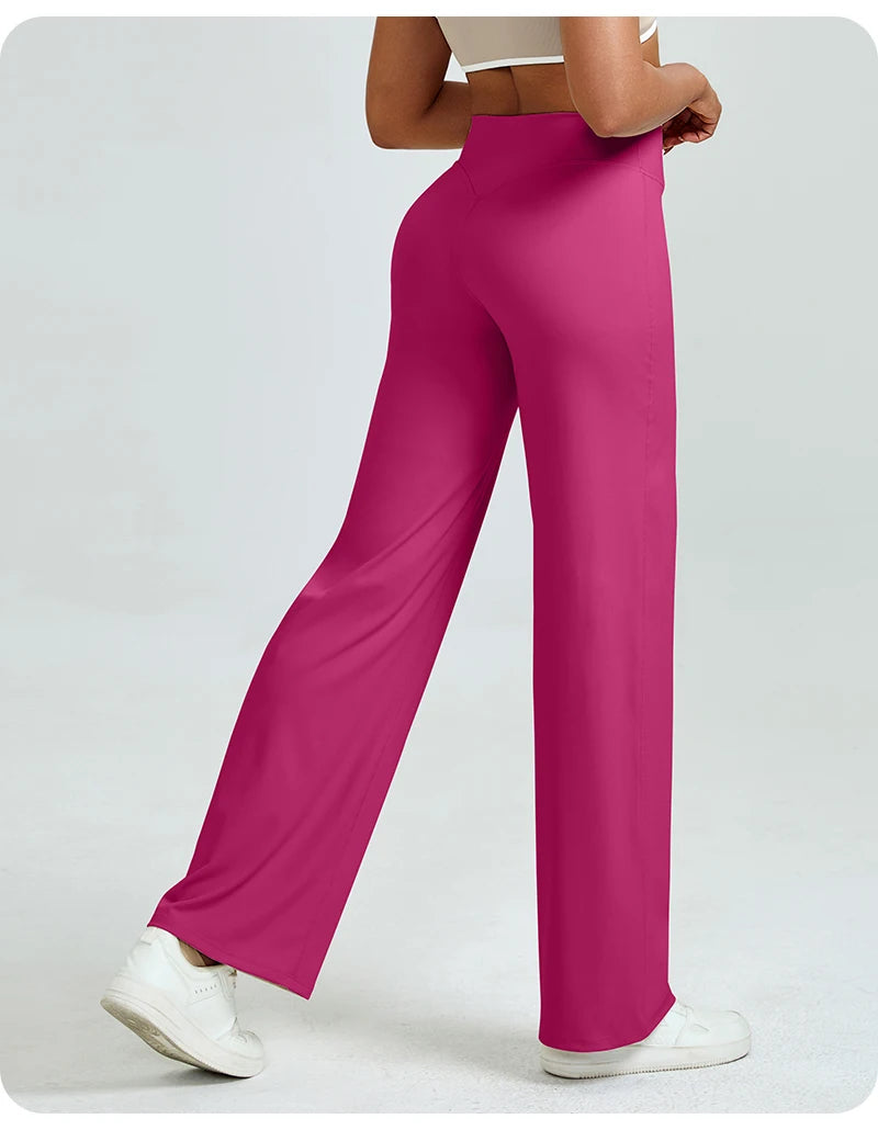 A woman is modeling high waisted magenta yoga pants and white sneakers.