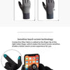 A pair of black touchscreen gloves with a conductive fiber tip shown next to a smartphone.