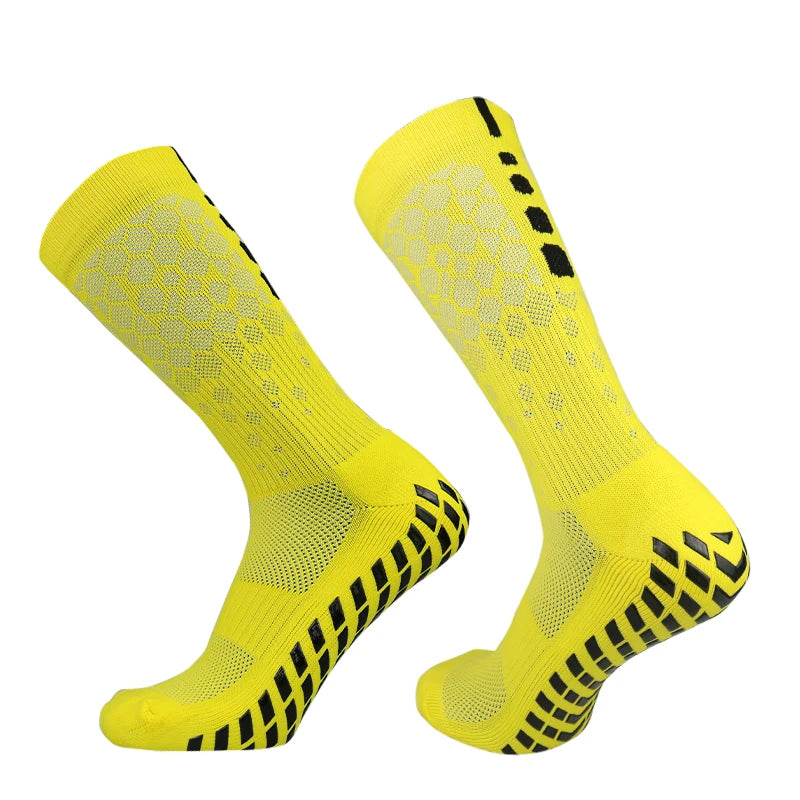 A pair of bright yellow honeycomb grip football socks shown from the side.