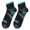 A pair of black compression socks with teal accents and arch support features.