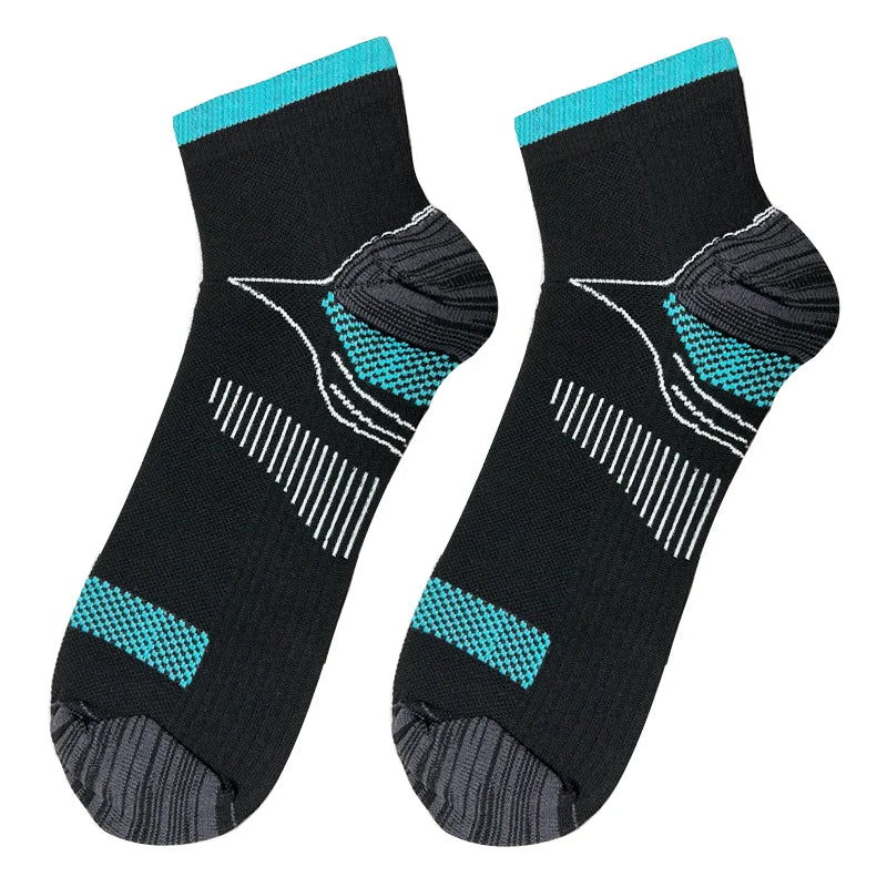 A pair of black compression socks with teal accents and arch support features.