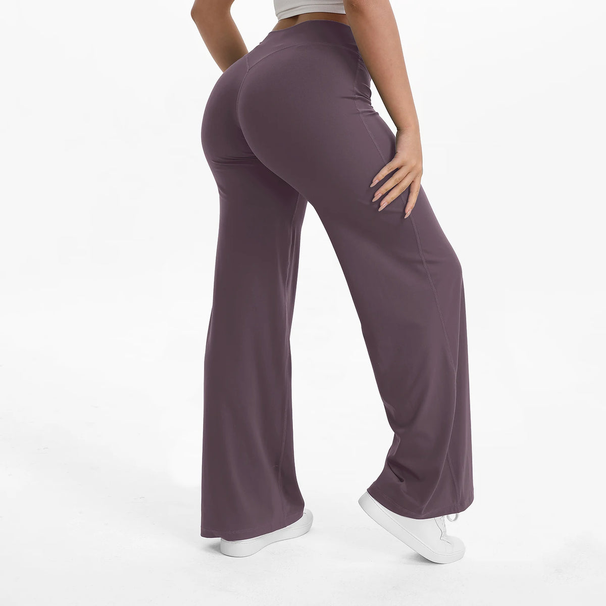 A person is modeling a pair of mauve NCLAGEN SoftMotion straight leg yoga pants.