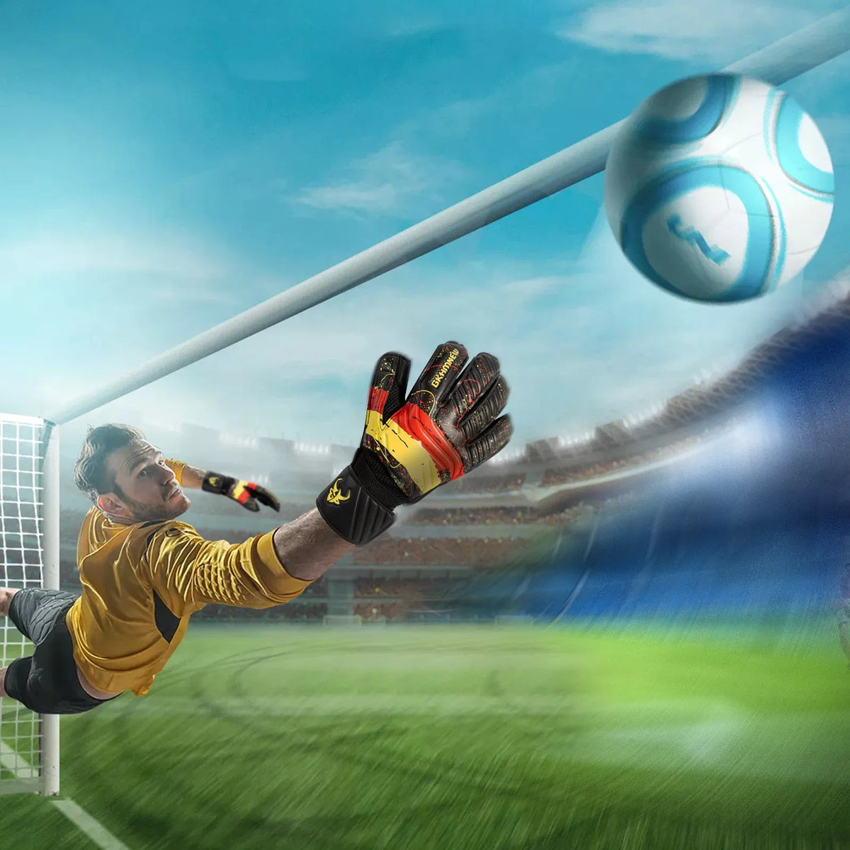 Portero con uniforme amarillo intentando atrapar un balón de fútbol con guantes negros y rojos frente a una red.