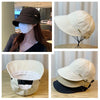 Gorra de béisbol de ala ancha beige con protección UV, mostrada en varios ángulos y contextos.