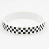 White silicone wristband with a black and white checkered pattern.