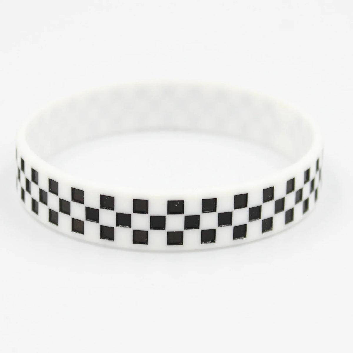 White silicone wristband with a black and white checkered pattern.