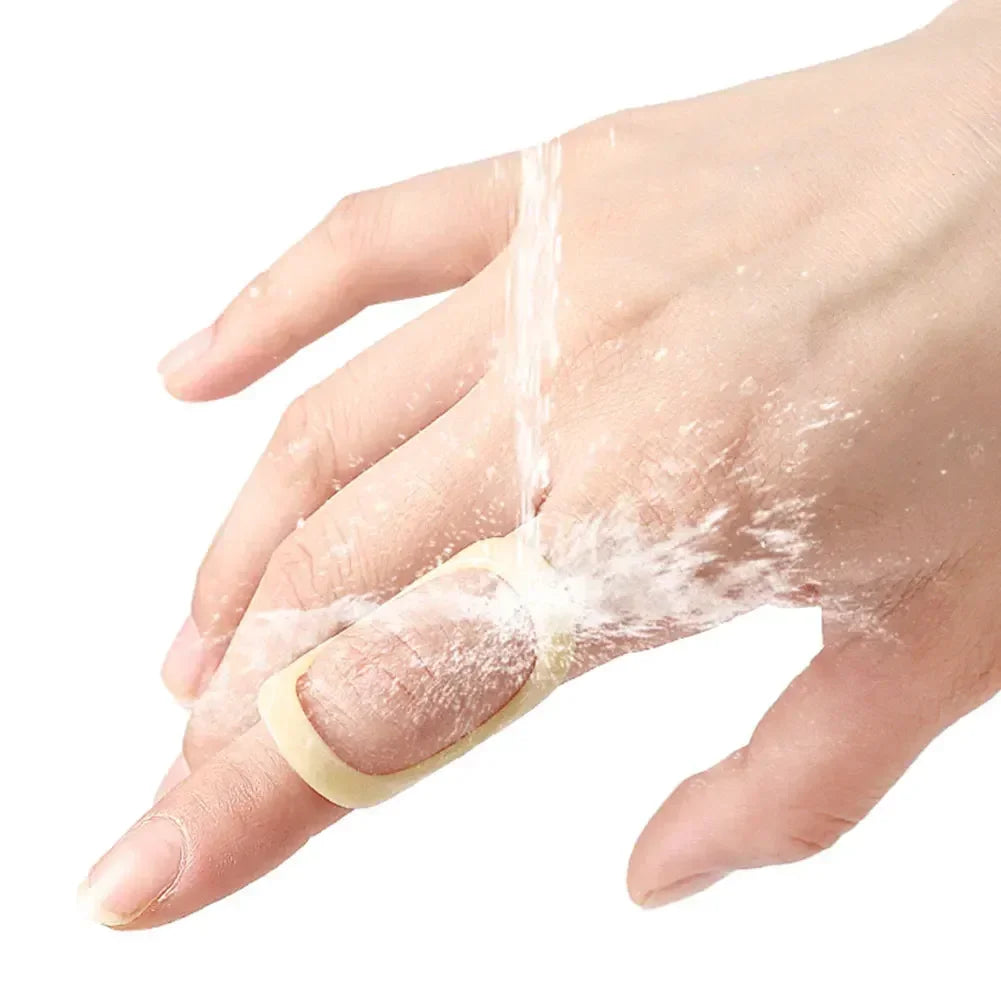 A hand is being washed under running water, showing soap suds and water flow.