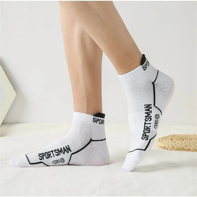 A pair of white men's breathable mesh performance socks with black stitching and the word SPORTSMAN visible on the foot.