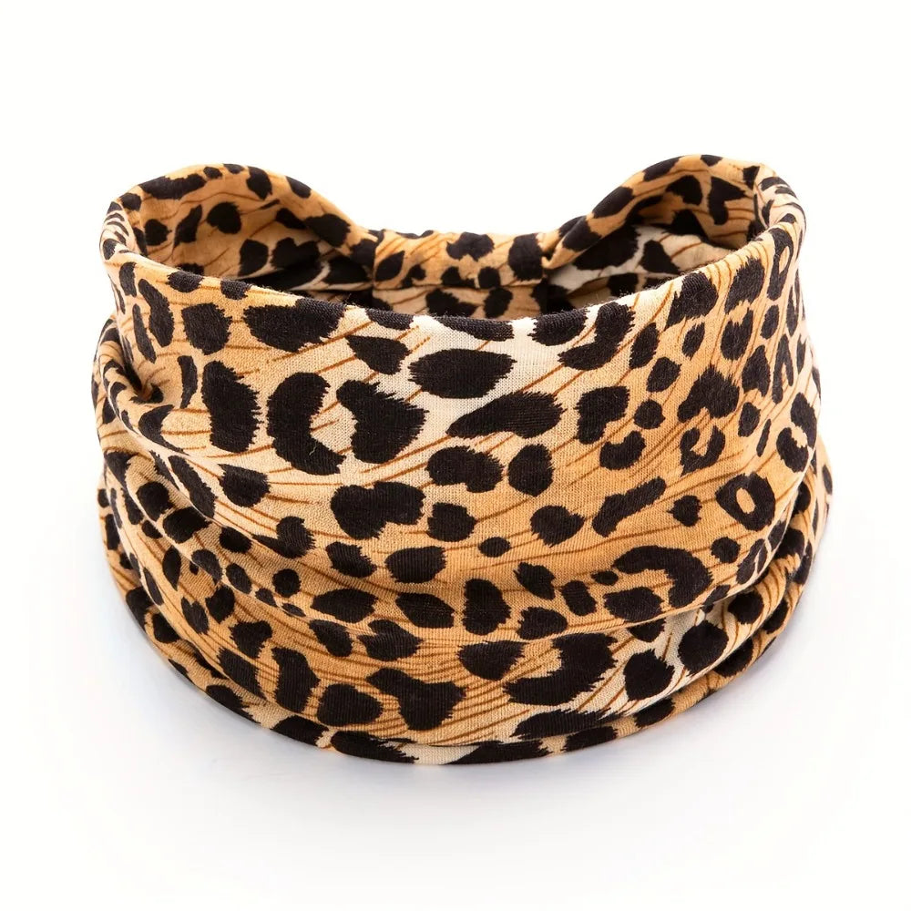 A close-up of a boho leopard print fabric headband rolled into a coil.