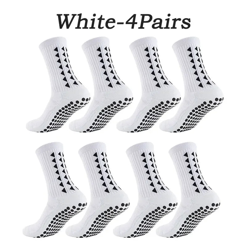Four pairs of white multi-sport athletic grip socks displayed together.