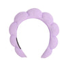 A lavender microfiber skincare headband and wristband set.