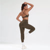 A woman models a leopard print seamless two-piece sports set consisting of a cropped top and leggings.