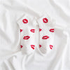 White socks with red lipstick print on the toes and heel
